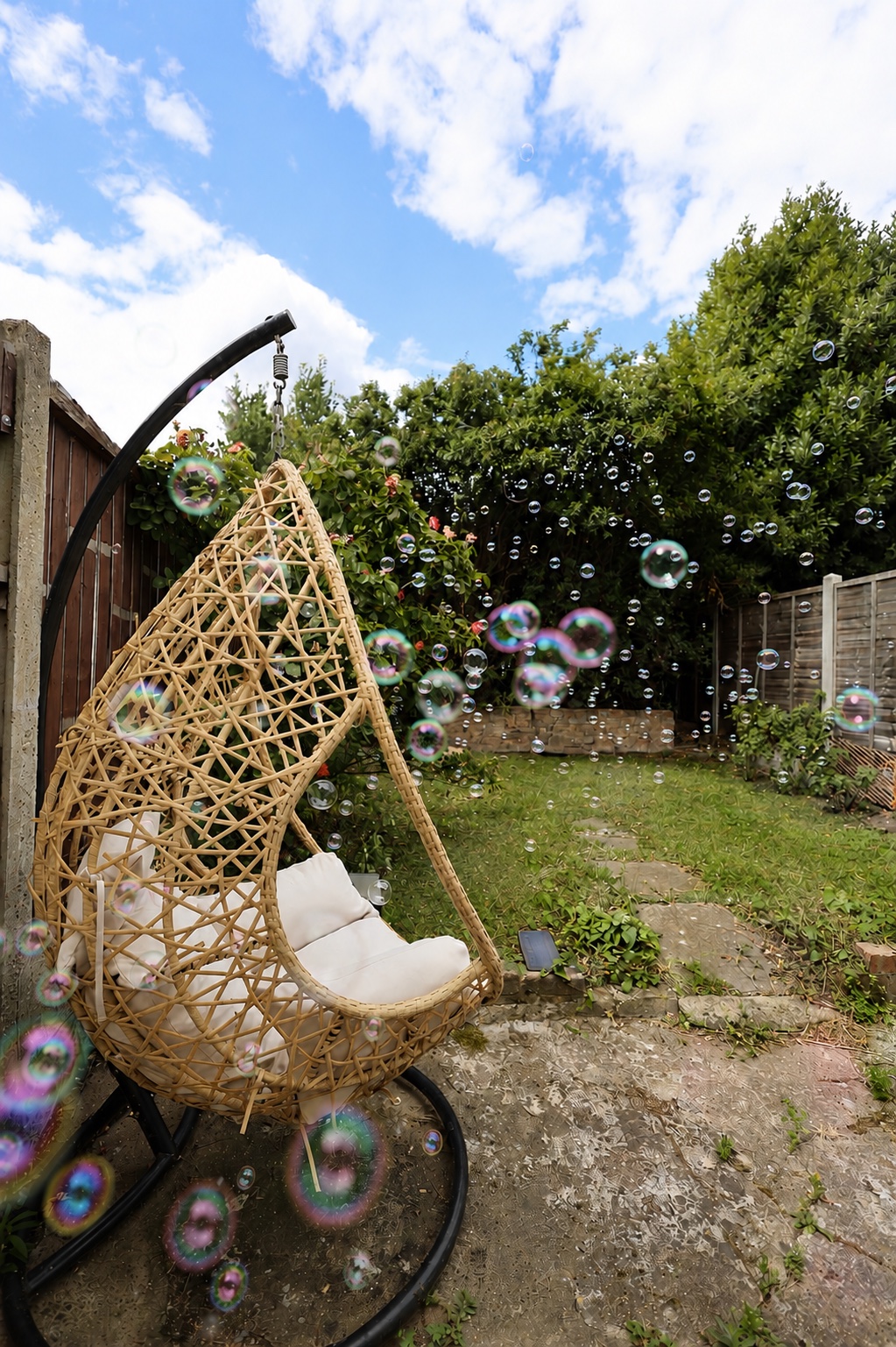 Bubbles floating through the Root and Bloom garden beside the hanging chair