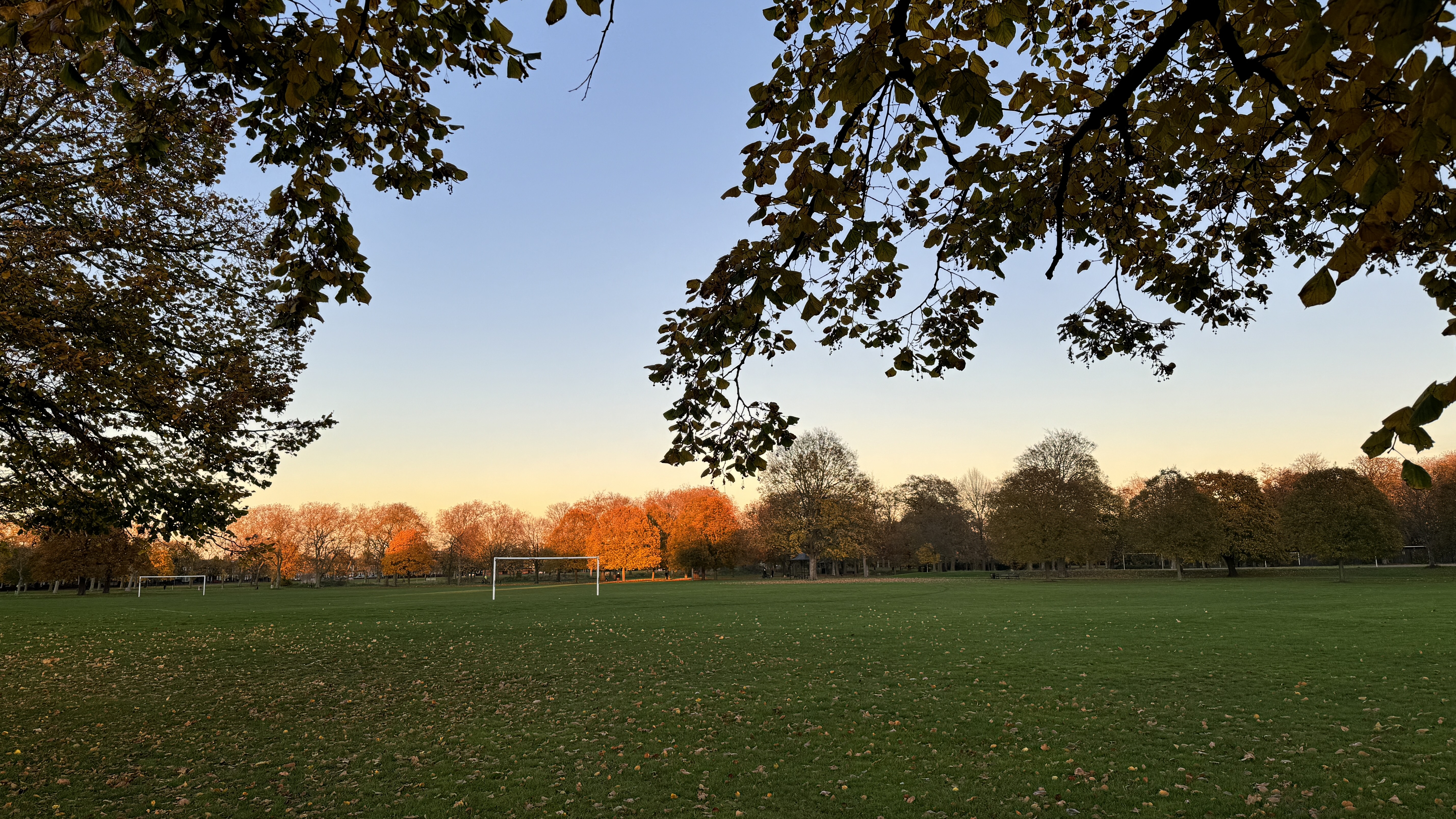 An autumn sunset over the open fields in West Ham Park